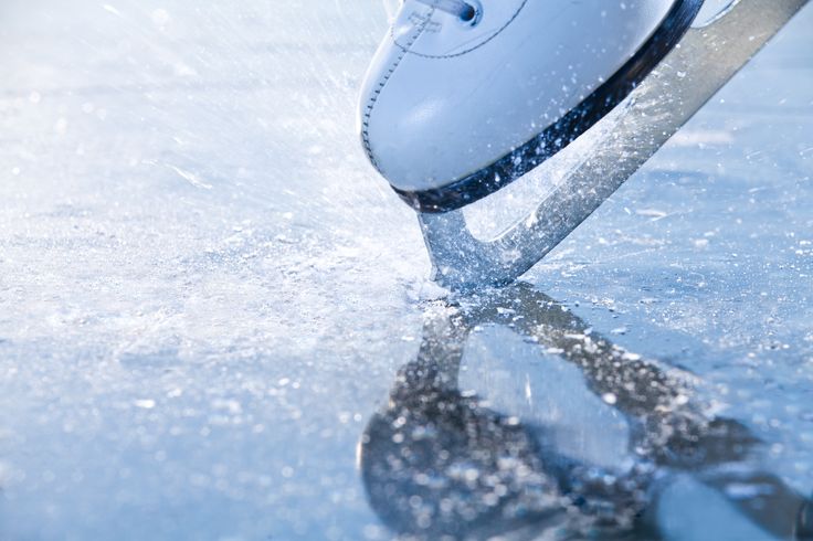 Woman skates braking ice, frazil flying around Woman skates braking ice, frazil flying around